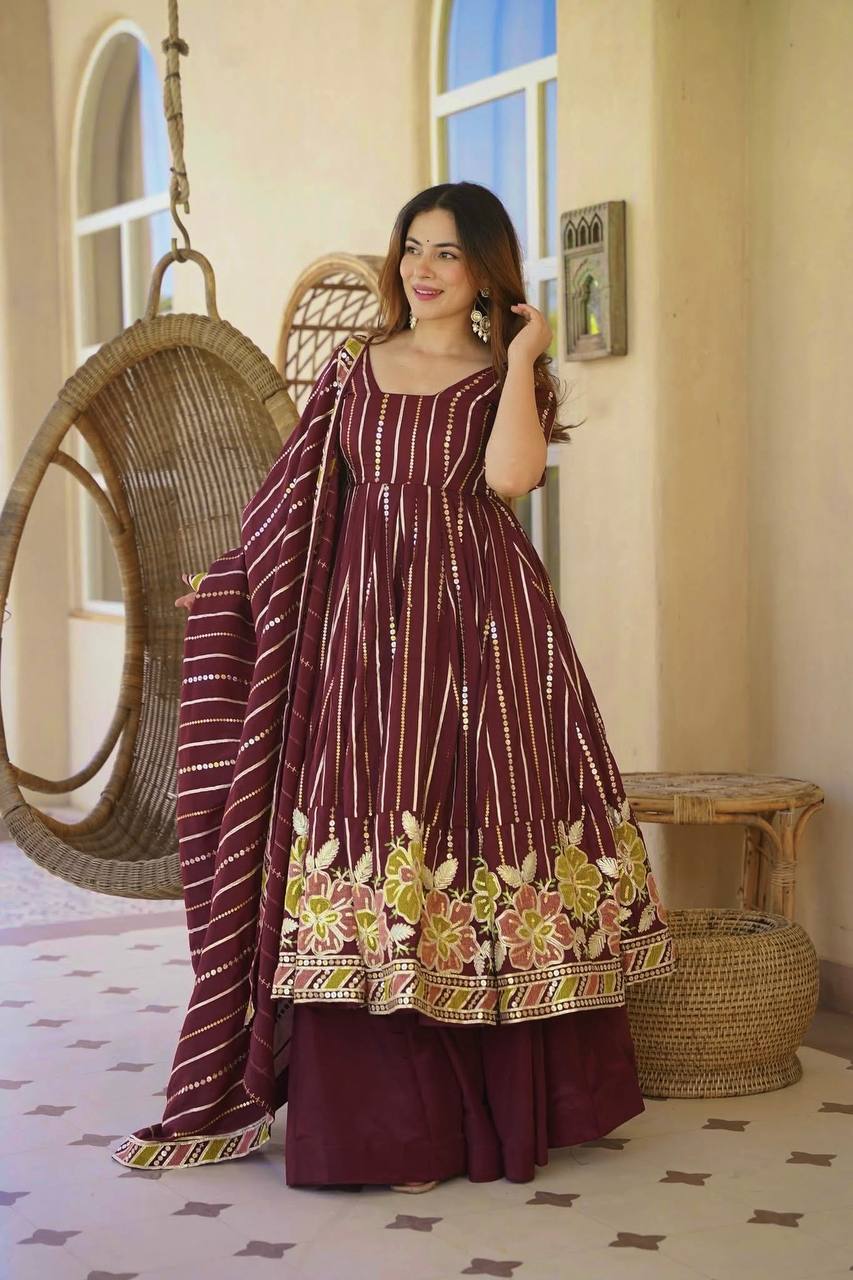 Majestic Maroon Flared Anarkali Suit Set Adorned with Luminous Sequin Stripes and an Ornate Floral Embroidered Hemline